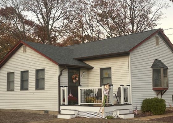 Finished single-story home exterior with a new front deck